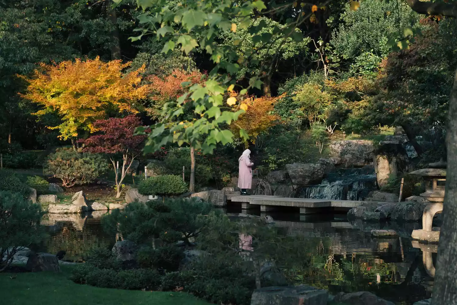 The peaceful stone paths and waterfall of the Kyoto Garden in Holland Park.