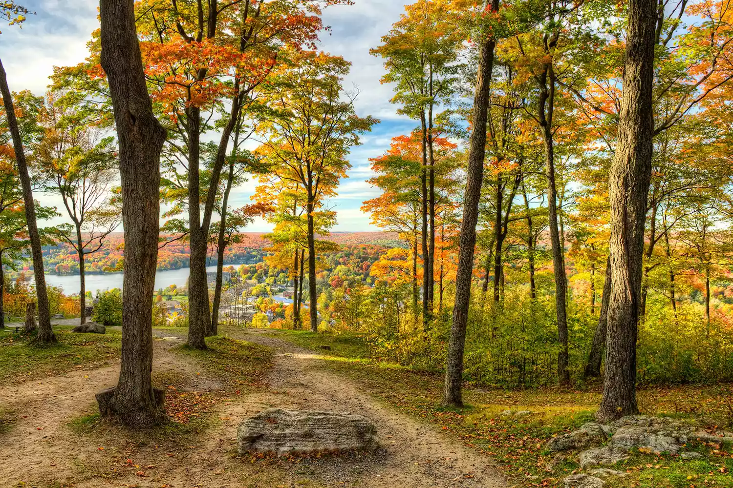 Campsite and calm waters reflecting vibrant autumn leaves at Algonquin Provincial Park.