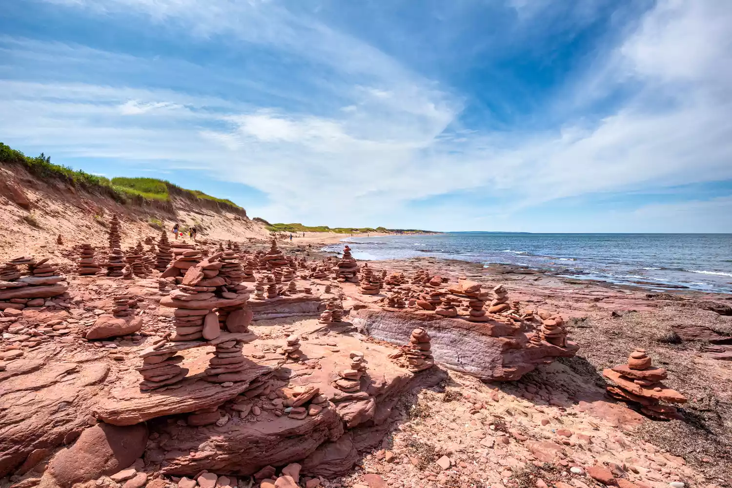 Red sandstone cairns and rock formations on the shore of Cavendish Beach in Prince Edward Island.
