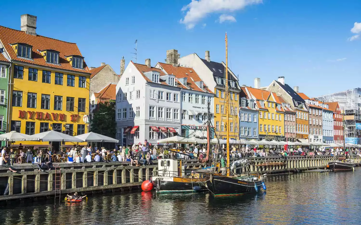 The iconic colorful buildings and boats of the Nyhavn waterfront in Copenhagen.