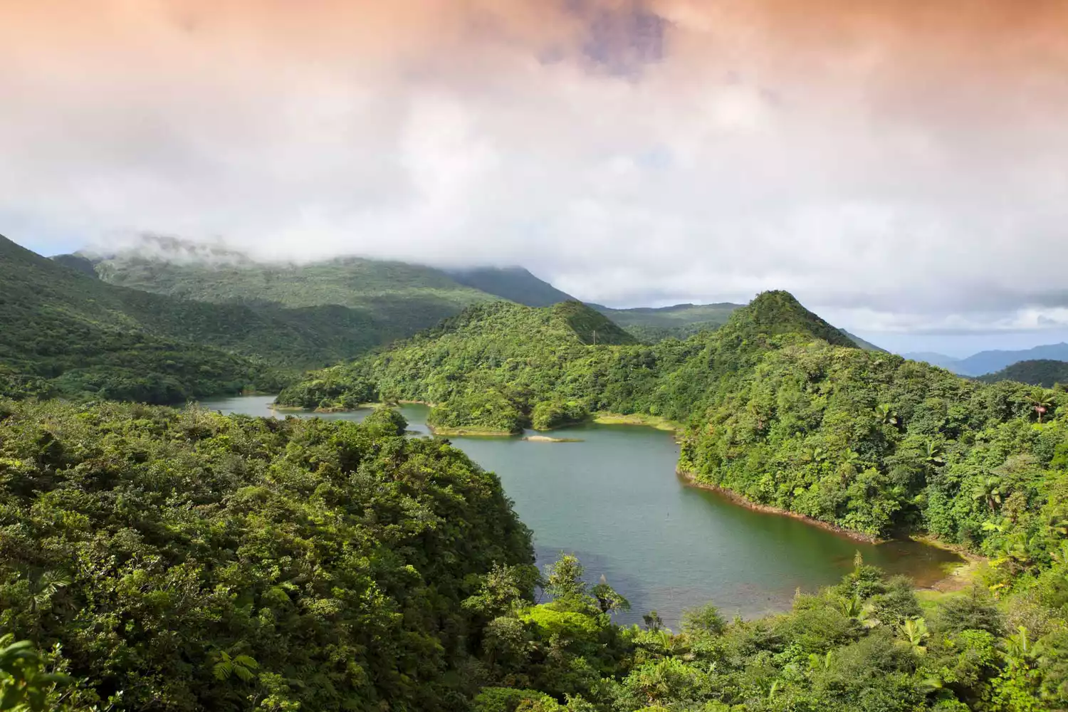 Dominica's Morne Trois Pitons National Park featuring a freshwater lake surrounded by dense rainforest.