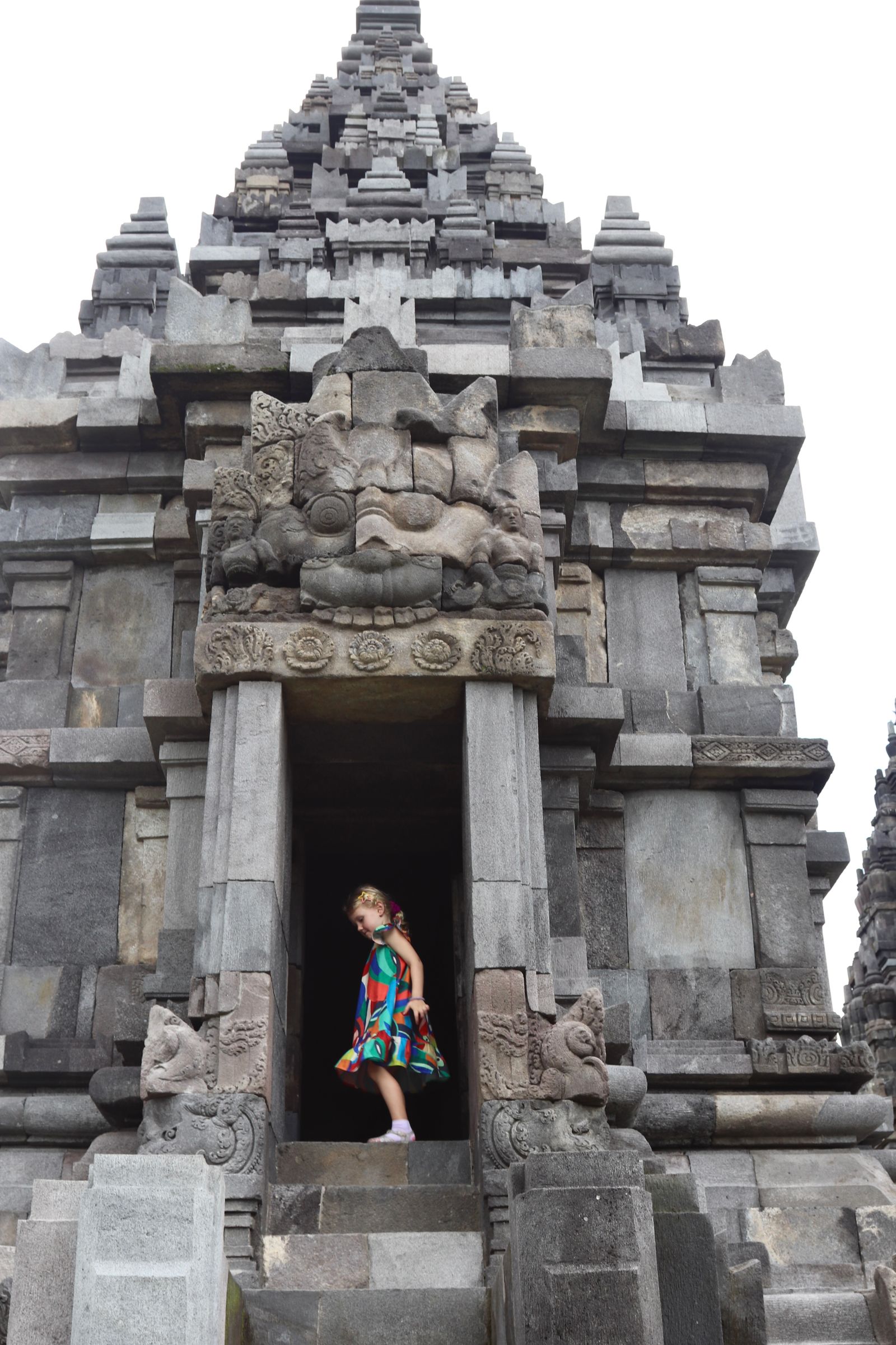 A traveler observing the intricate stone stupas of Borobudur Temple.