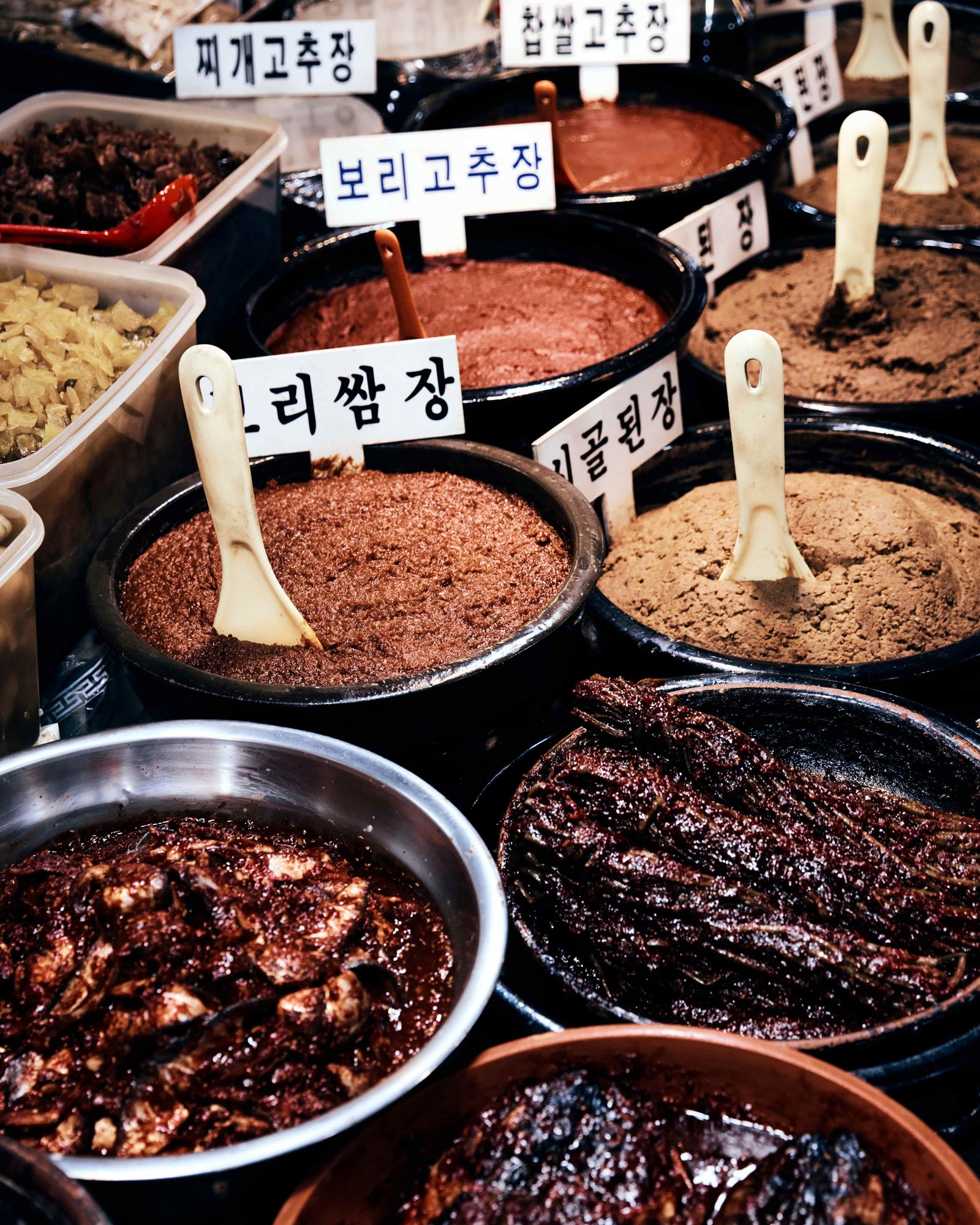 Authentic street food display at Gwangjang Market with various traditional dishes.