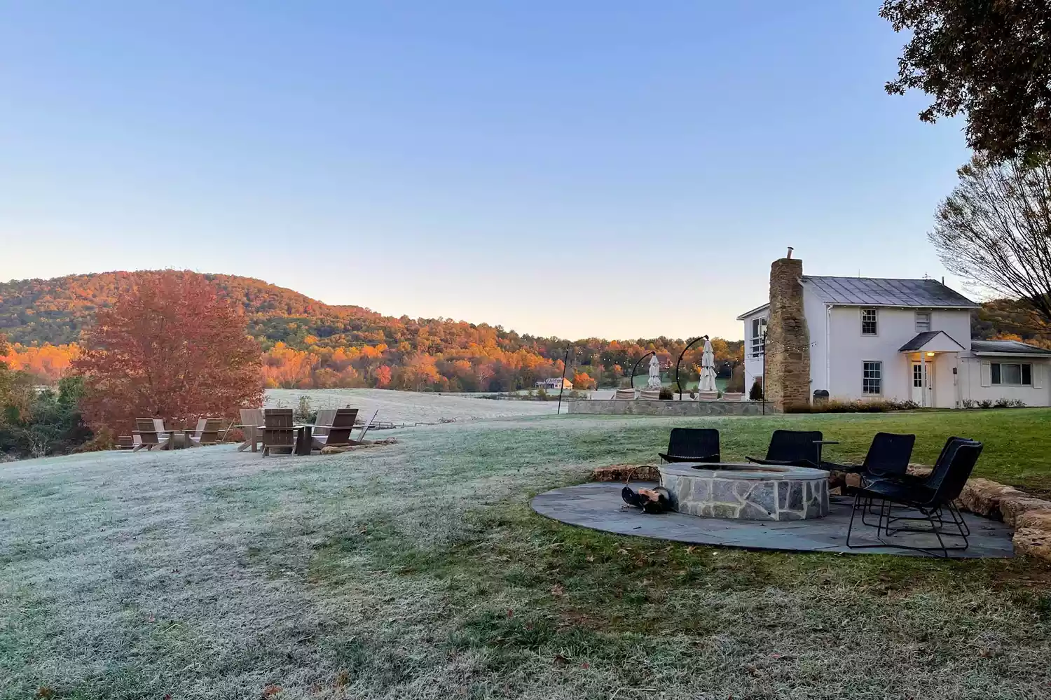 The manicured lawn at Blue Rock showing vibrant autumn foliage and mature trees.